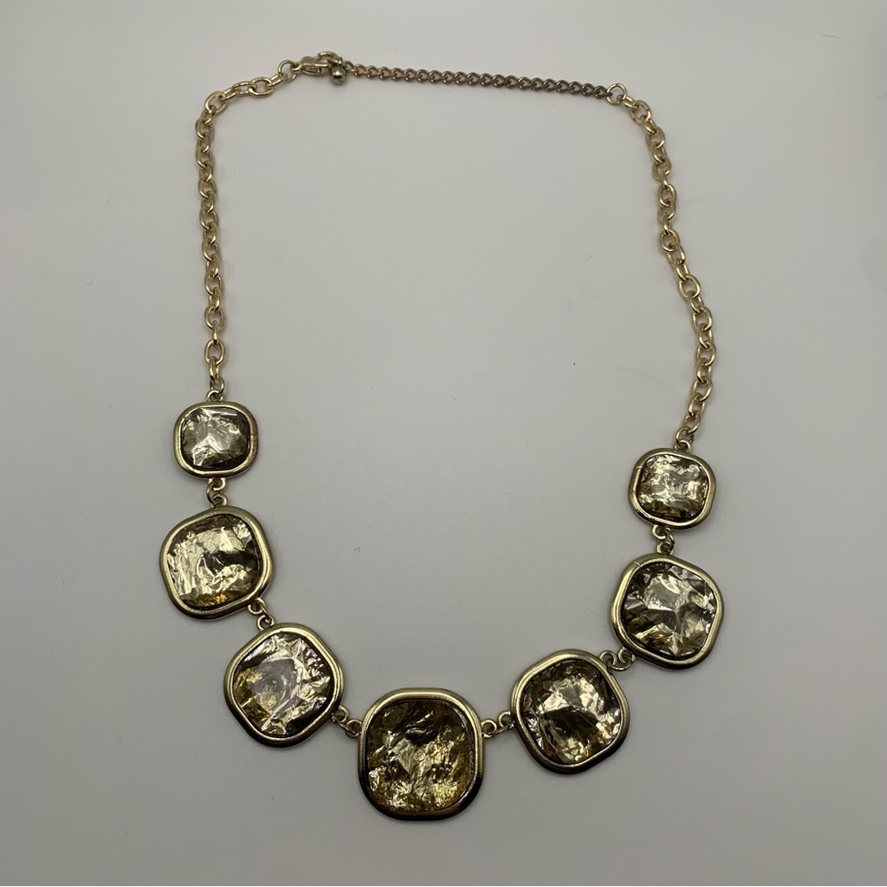 Gold tone statement necklace with faux green stones
